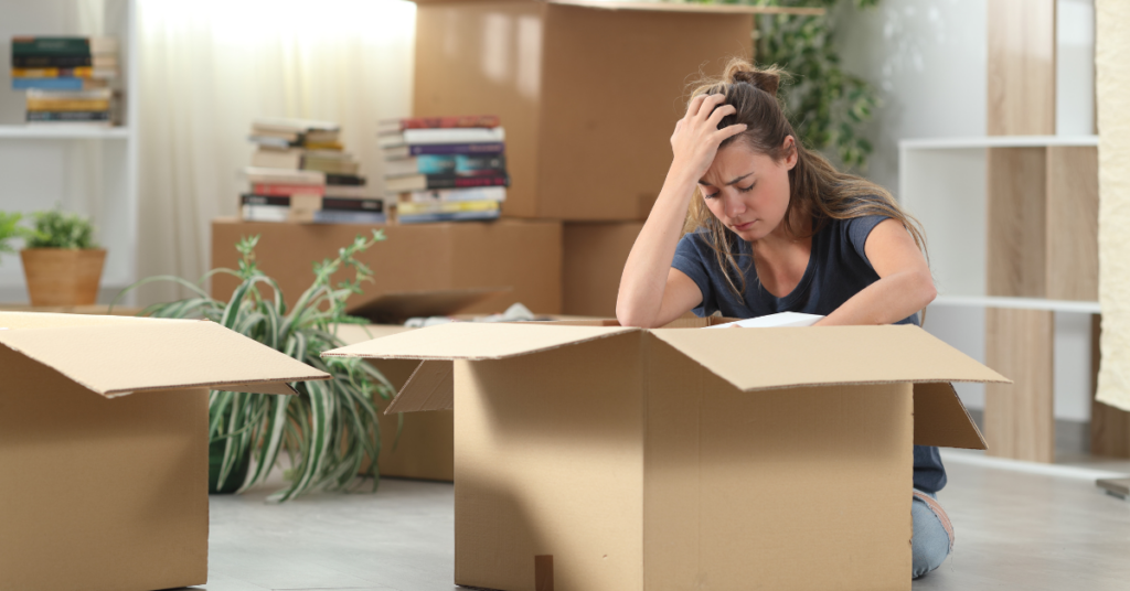 Woman unpacking boxes in her new home. 