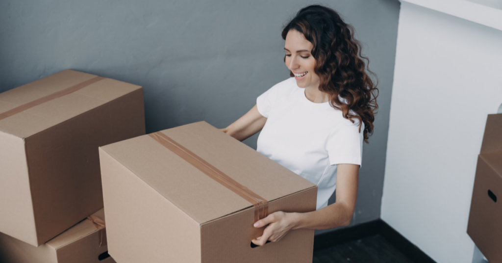 Woman moving a big box 