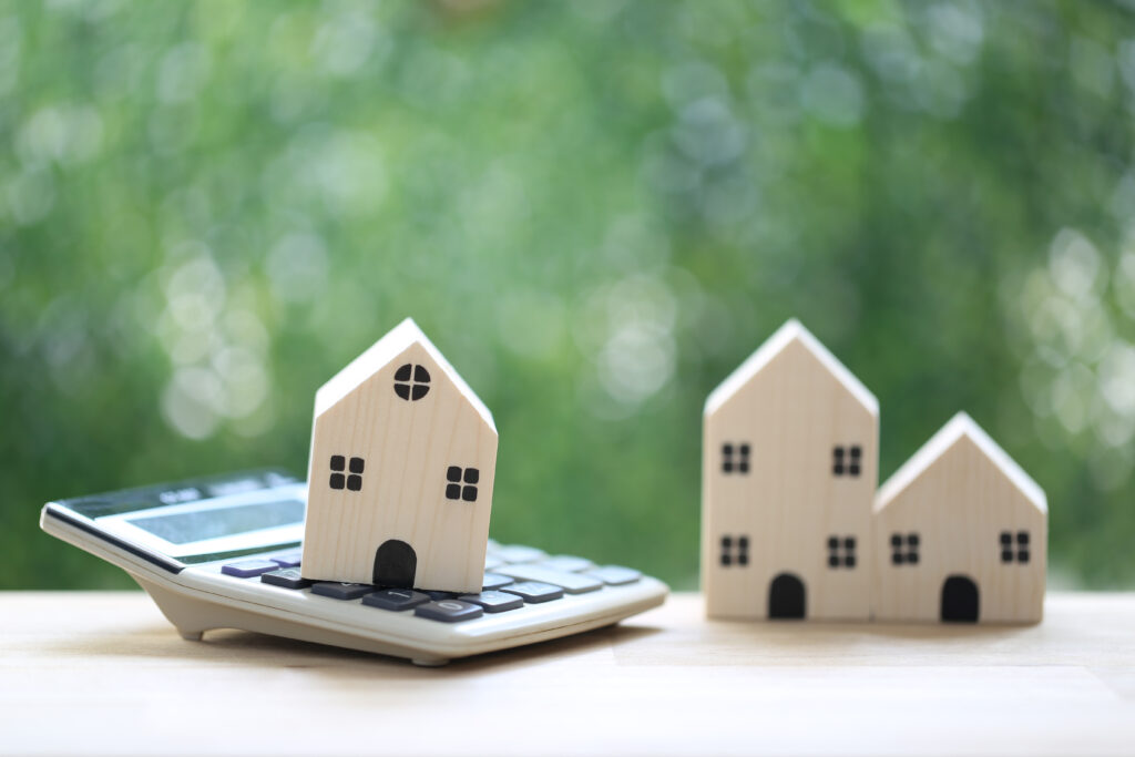 Estate tax,Model house on calculator with tax word on natural green background,Business investment and Property tax concept