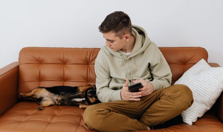 Tenant sitting on a sofa beside a small dog in a rental home, reflecting new pet request rights under the Renters’ Rights Act 2025