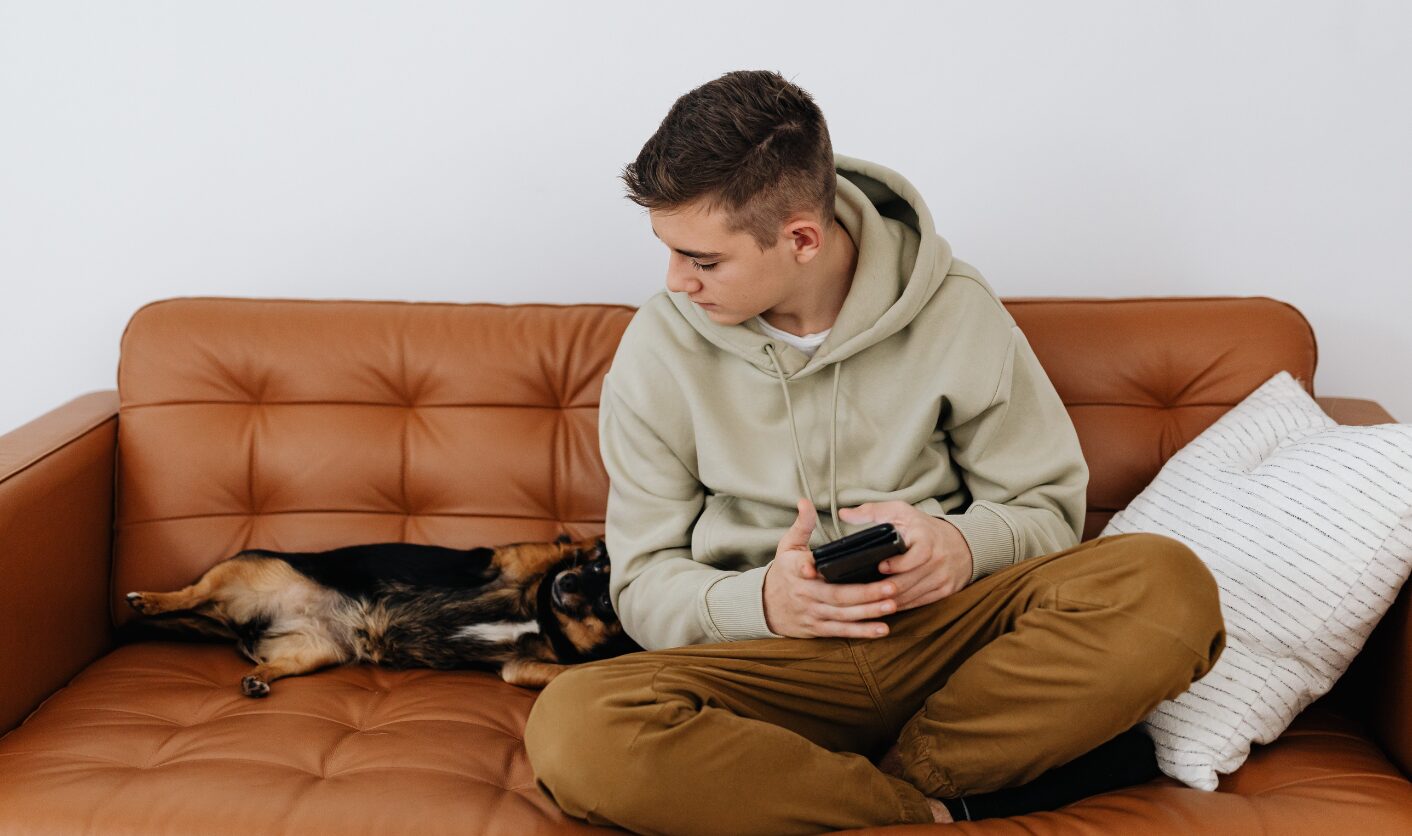 Tenant sitting on a sofa beside a small dog in a rental home, reflecting new pet request rights under the Renters’ Rights Act 2025