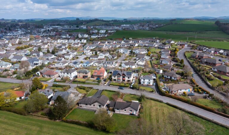 Aerial view of suburban homes and neighbourhood streets in Northern England or Scotland