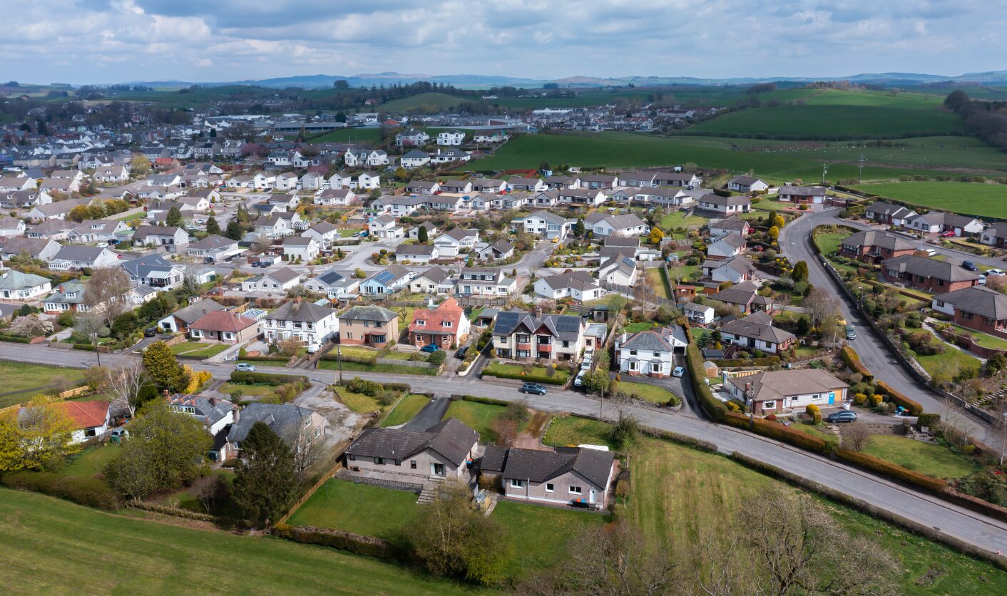 Aerial view of suburban homes and neighbourhood streets in Northern England or Scotland