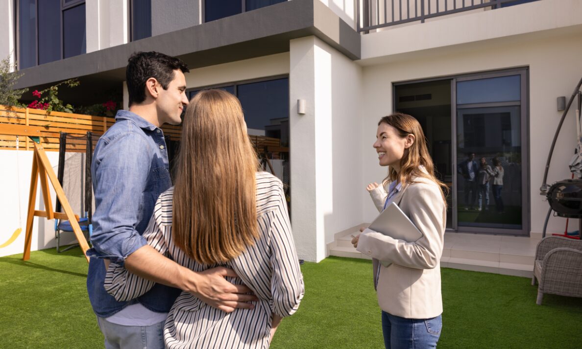 Estate agent presenting property to couple during house viewing in St Helens