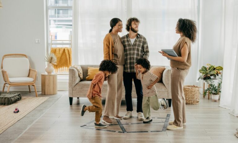 Family with estate agent viewing a spacious modern home in Ipswich discussing property options Image Title: ipswich-family-home-viewing