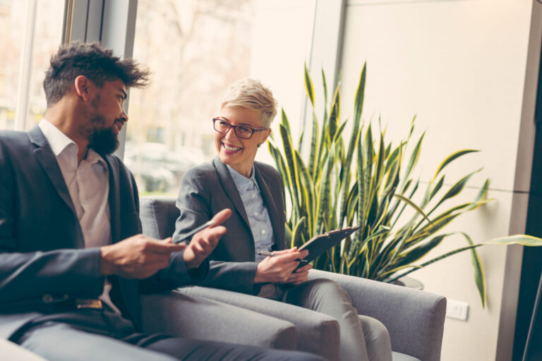 Young professionals discussing property investment in a modern living room in a Warrington village