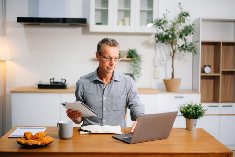 landlord reviewing rental income and property strategy on laptop at home
