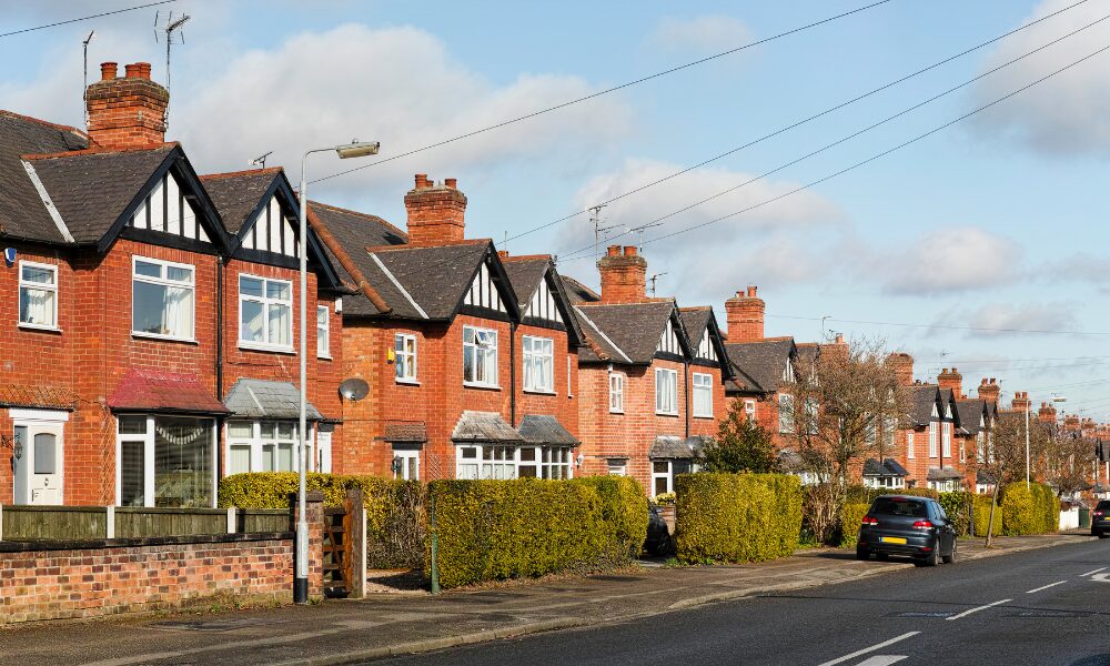 Row of traditional red brick houses along a residential street in Coventry