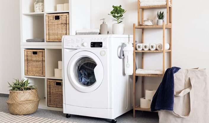 modern laundry room with washing machine, shelves, and neatly organized towels and storage baskets