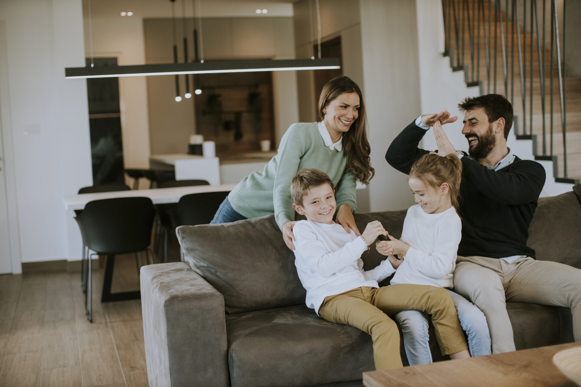 Happy family relaxing together in a modern living room representing ideal family homes in Walsall