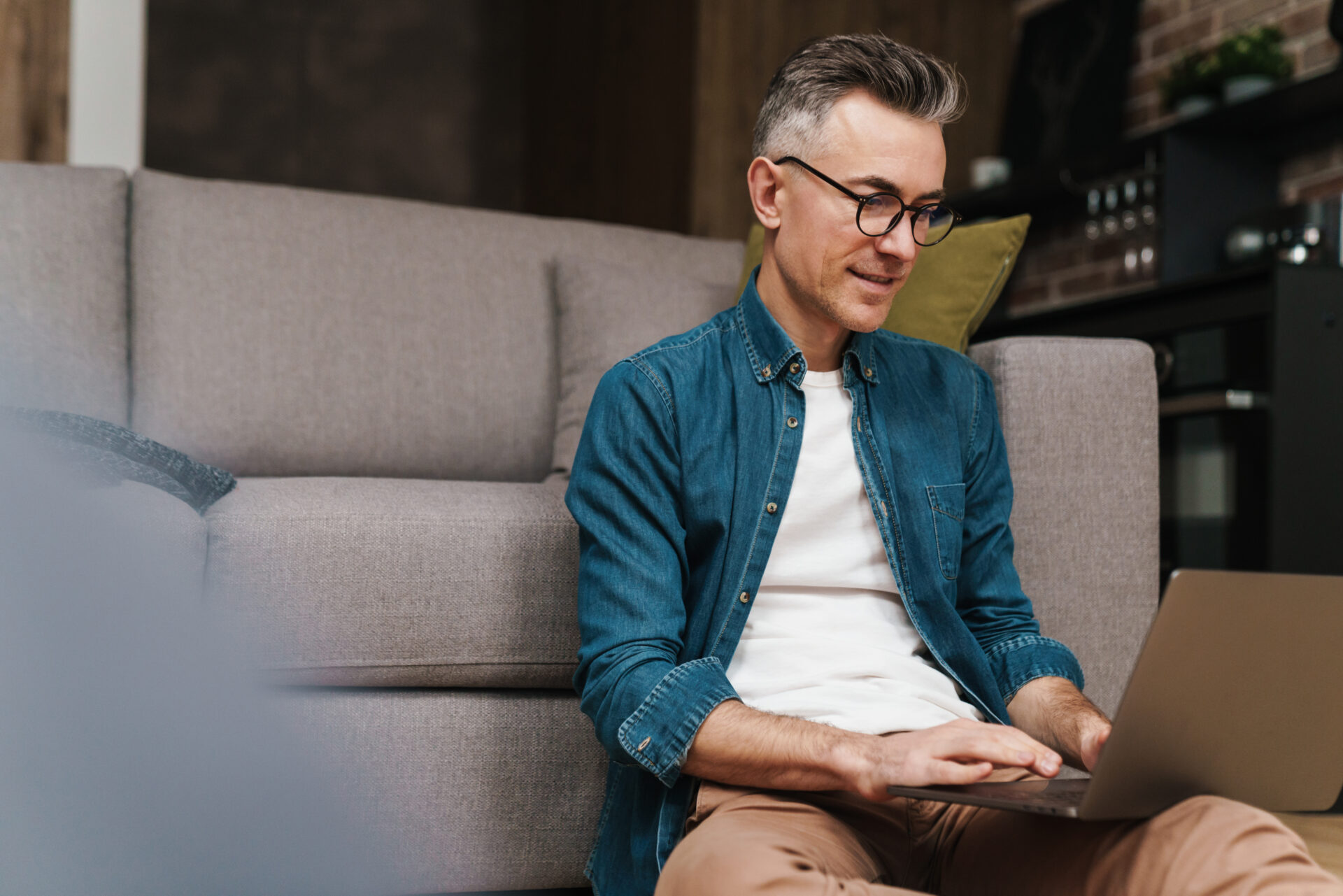 Landlord using a laptop at home reviewing property security and rental management