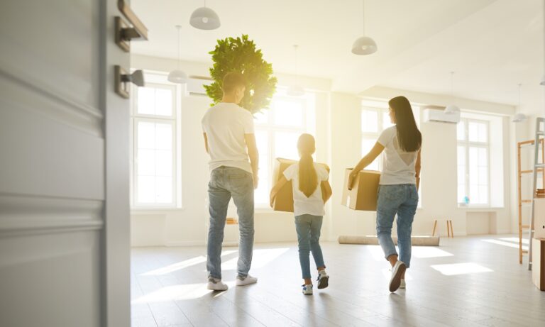 Young couple unpacking boxes in a modern Morley rental property in LS27 during a house move
