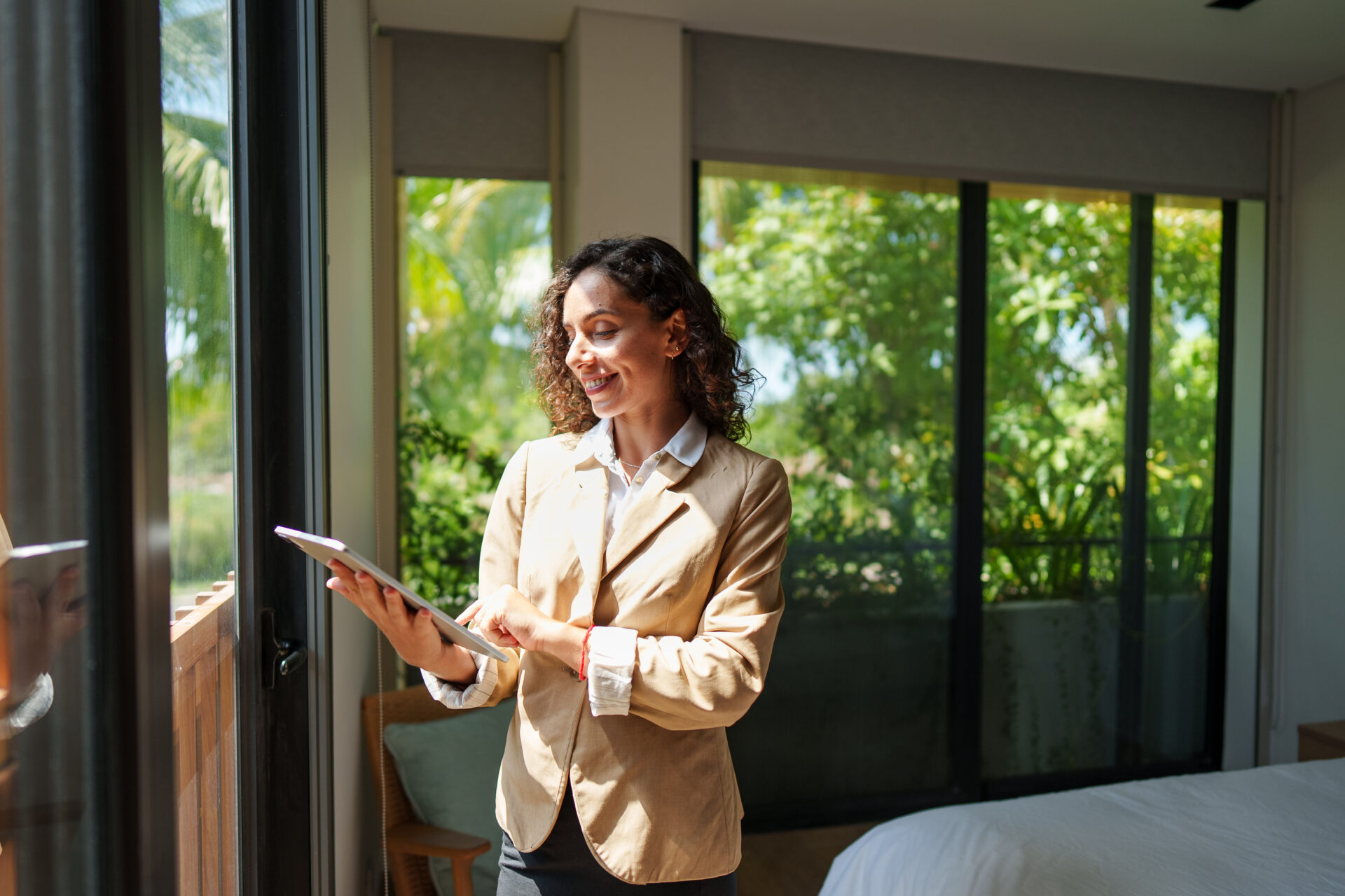 Female letting agent using a tablet during a rental property inspection in Swansea.