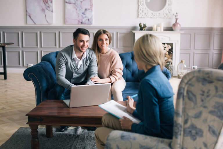 Young couple discussing a rental property with a letting agent in a modern Tilehurst home.