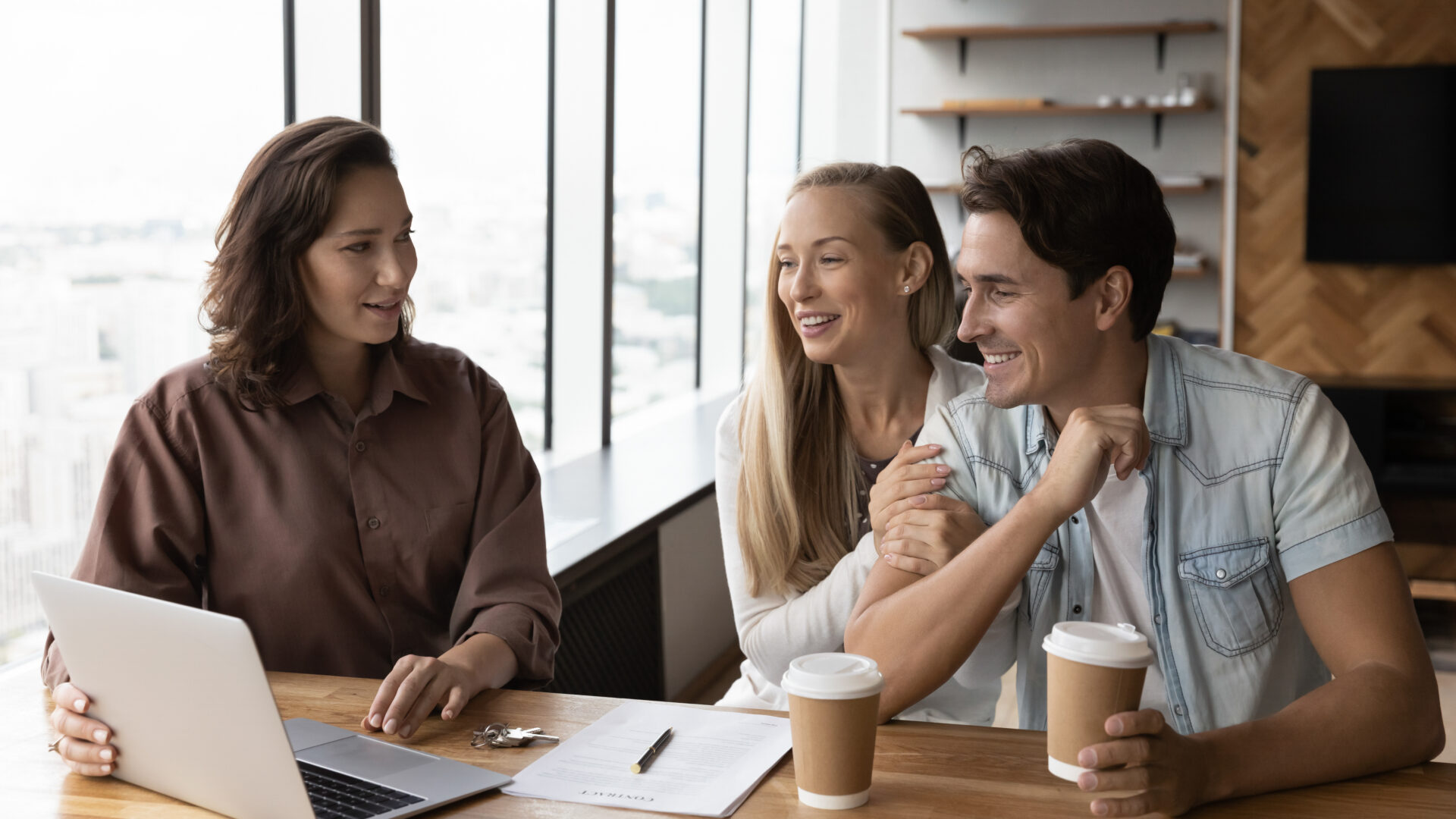 Letting agent advising a couple at a desk, representing Tunbridge Wells rental yields and buy-to-let investment guidance.