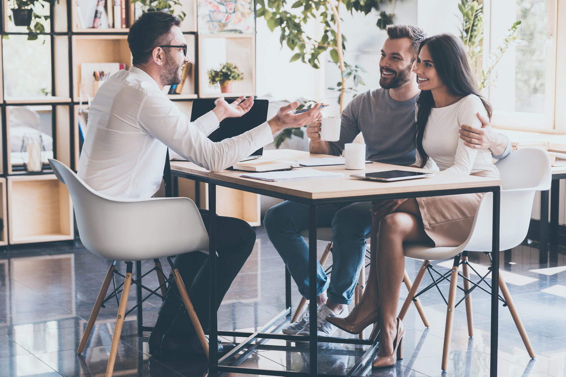 Property adviser speaking with a couple at a desk, representing Brighton rental yields and buy-to-let investment guidance.