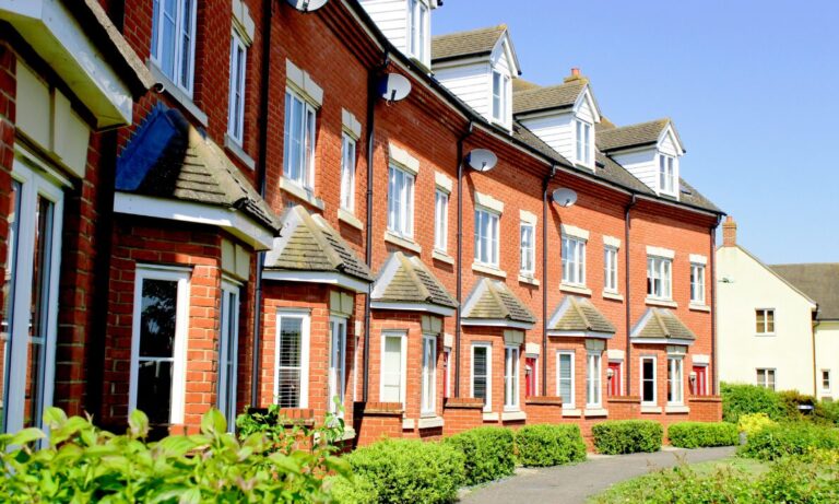 Row of red-brick townhouses representing Haywards Heath house prices and family buyer demand in Mid Sussex.