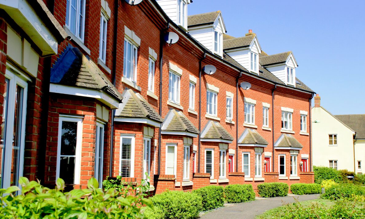 Row of red-brick townhouses representing Haywards Heath house prices and family buyer demand in Mid Sussex.
