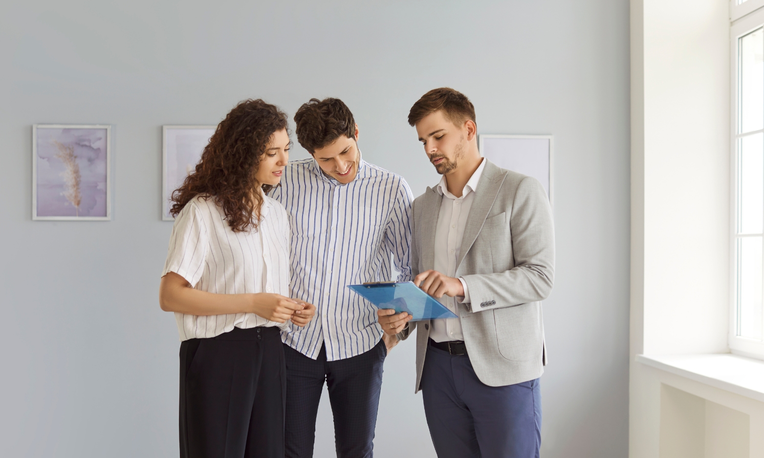 Property consultant advising a couple about buying or renting a home in IP4 Ipswich, one of Suffolk's most desirable residential postcodes.