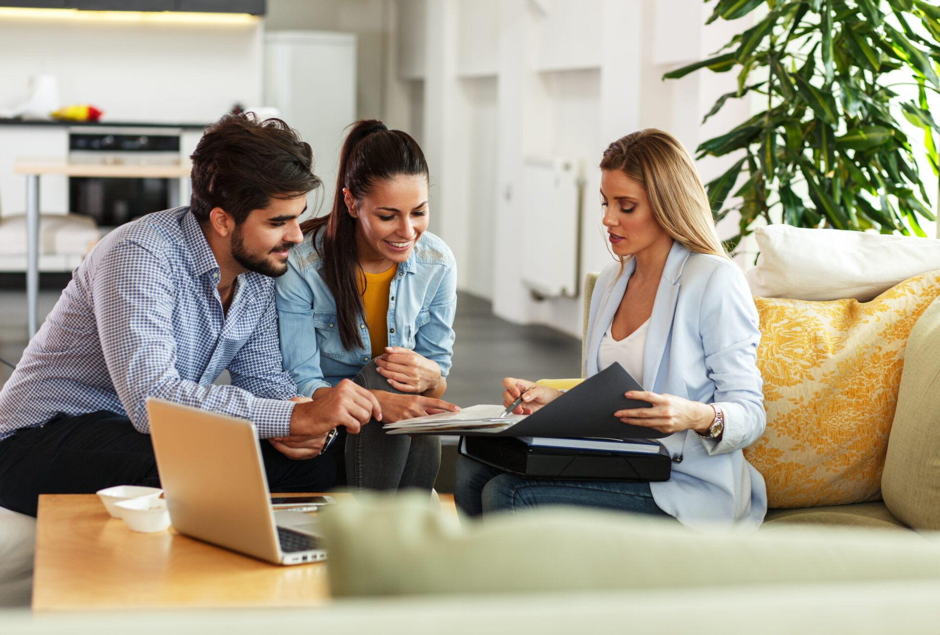 Letting agent reviewing property paperwork with a couple, representing Making Tax Digital guidance for Cardiff landlords.