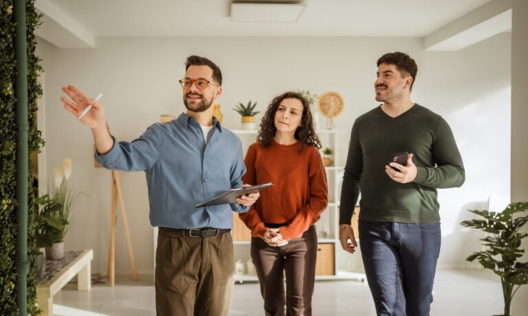 Estate agent showing a couple around a home, representing Wednesbury house valuations and buyer demand across WS10.