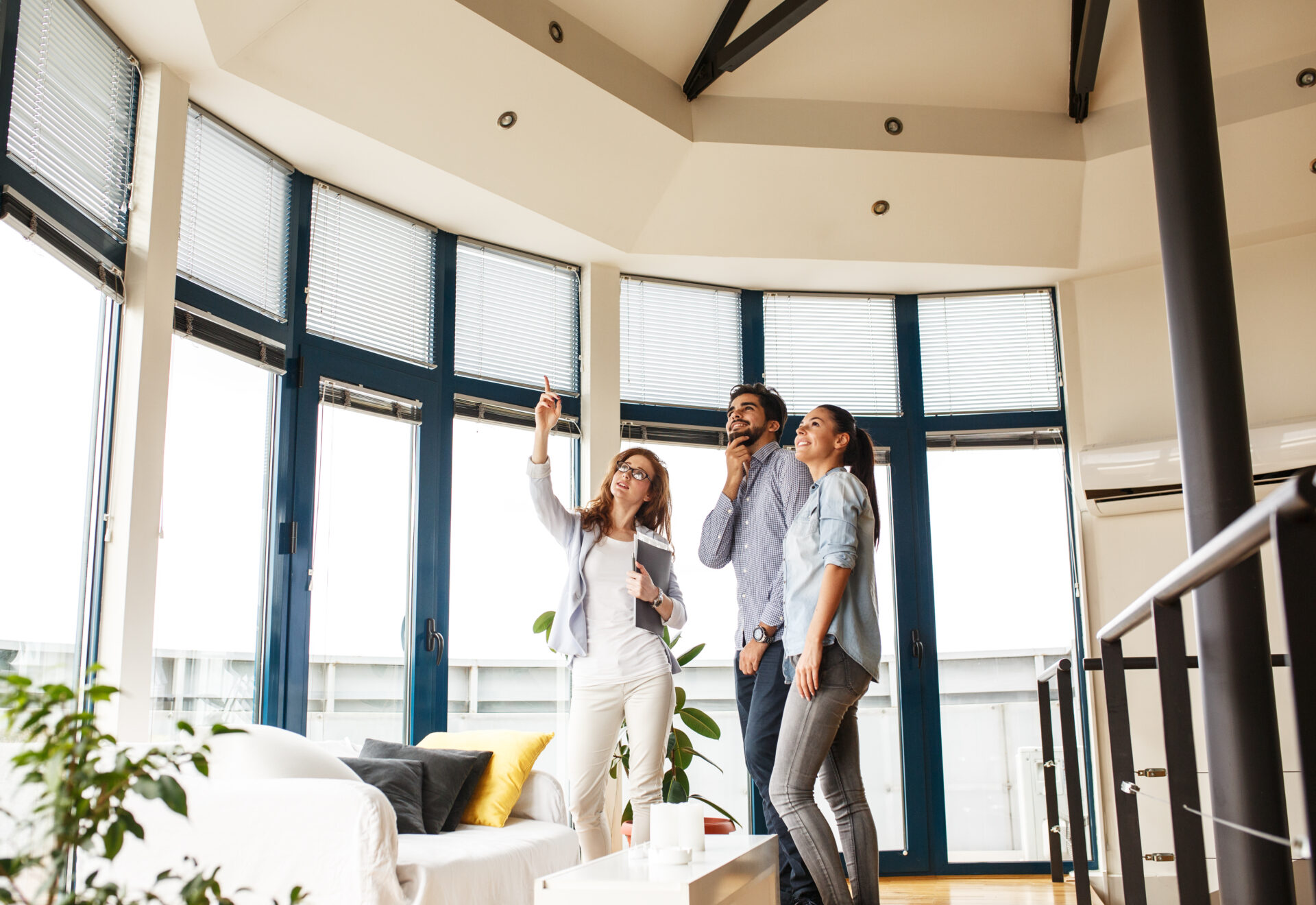Letting agent showing tenants around a bright rental property, representing Wigan selective licensing and landlord compliance in 2026.