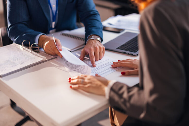 Property professional reviewing documents with a landlord, representing Making Tax Digital guidance for Swansea rental property owners.