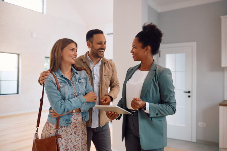 Letting agent speaking with a couple inside a property, representing professional advice for landlords renting out homes in Morley.