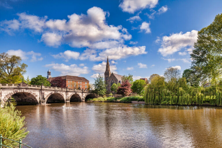 A scenic view of Shrewsbury with the River Severn, bridge and historic buildings, representing the local area served by Belvoir Shrewsbury estate agents.