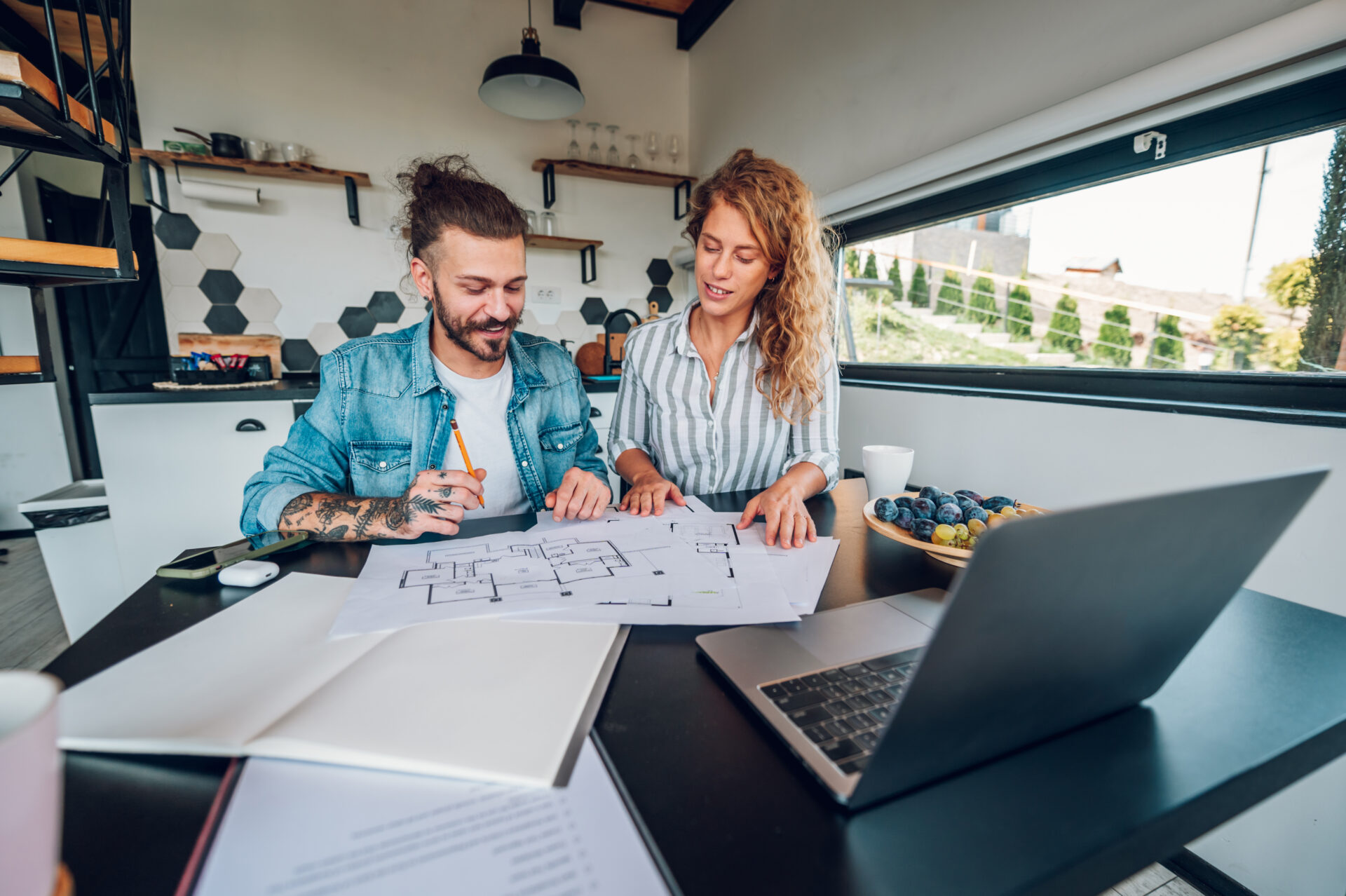 Couple reviewing property plans at home, representing buyers exploring homes in Brighton Marina BN2.