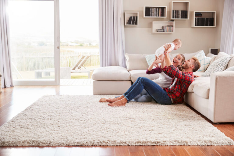 Young family enjoying time together in a bright living room, representing family life and living in Cuckfield RH17.
