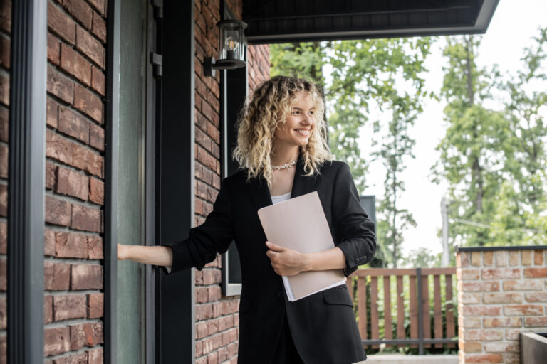 Estate agent standing at the front door of a property, welcoming prospective buyers in Fazeley B78.