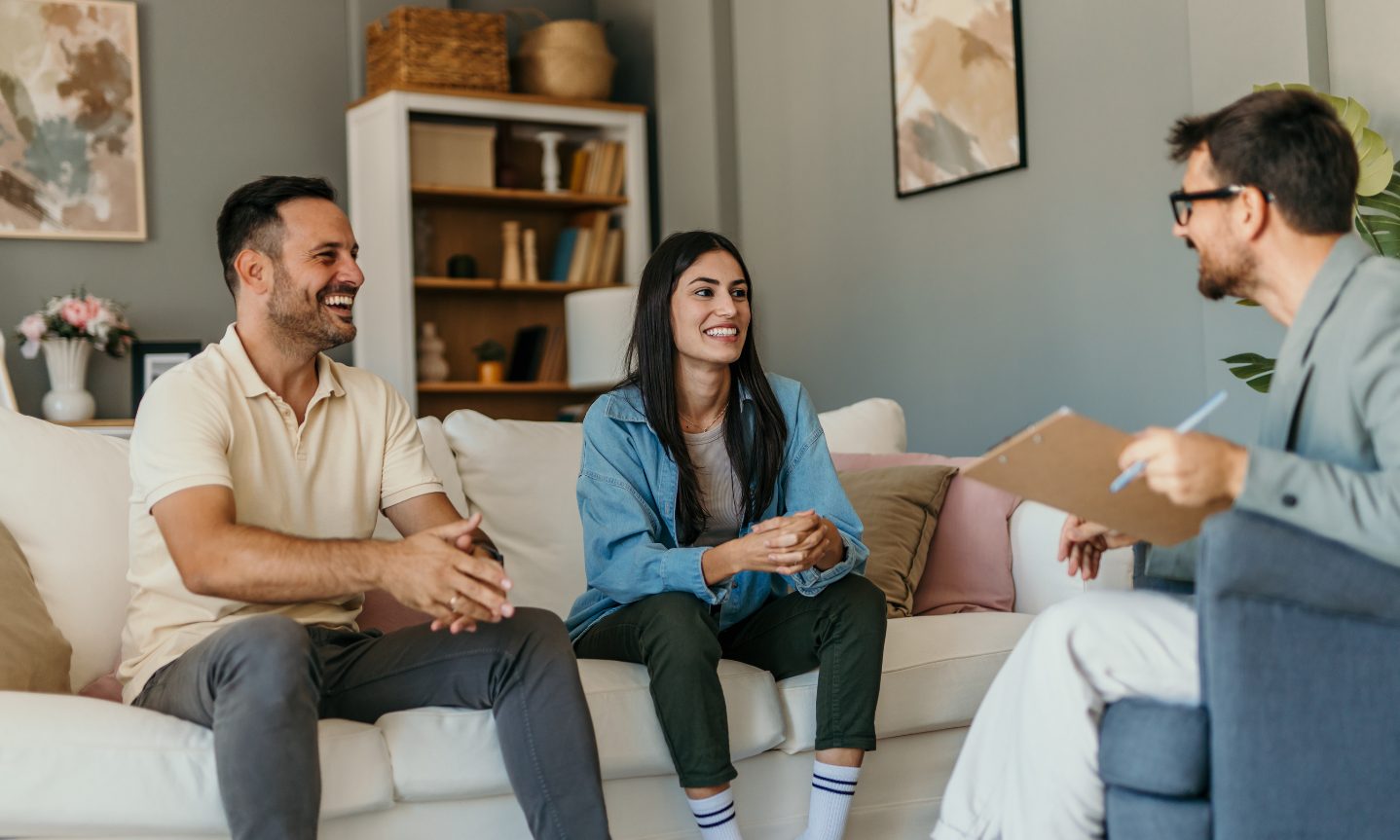 Landlords discussing property paperwork with a professional in a modern home