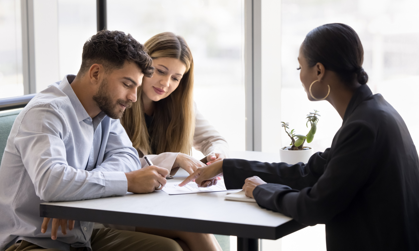 Couple discussing tenancy paperwork with a letting agent following Renters' Rights Act changes.