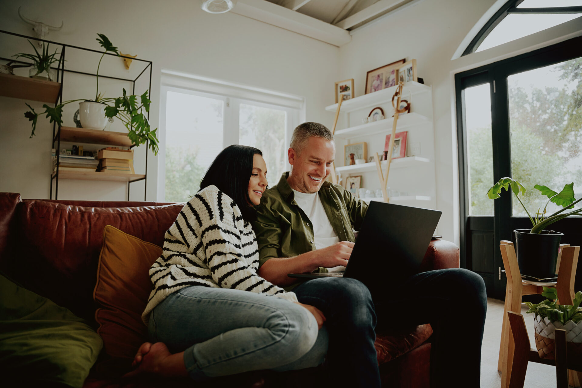 Young family enjoying time together in a bright living room, representing family life and living in Cuckfield RH17.