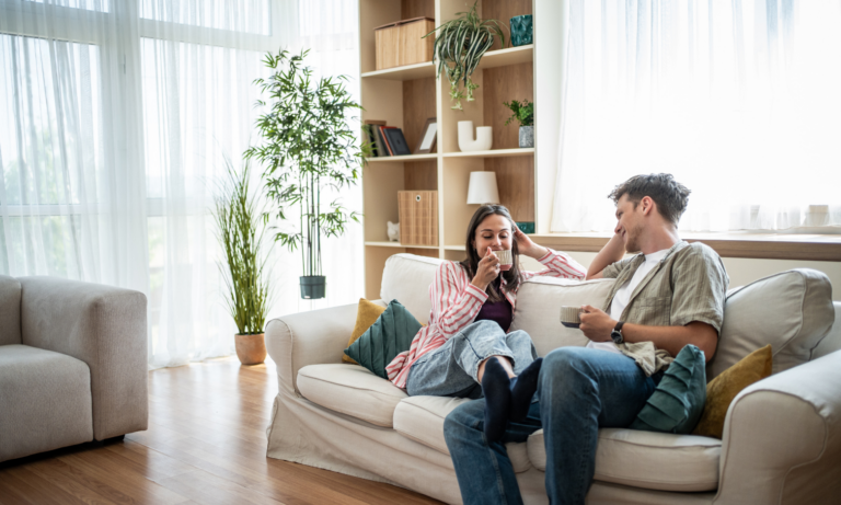 Young couple relaxing together in a bright modern rented home