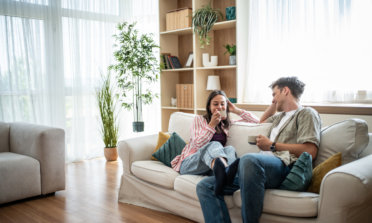 Young couple relaxing together in a bright modern rented home