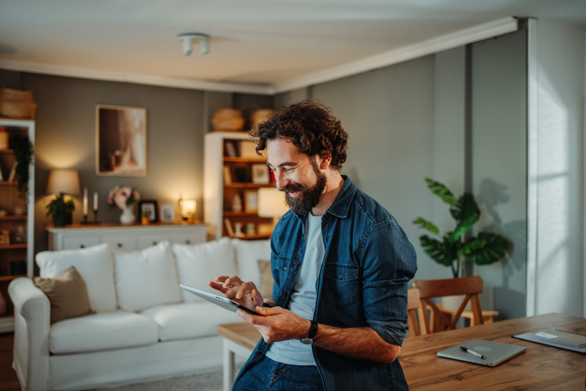 Man using a tablet in a comfortable modern home in Eccleston