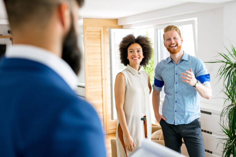 Property agent meeting prospective tenants during a rental property viewing
