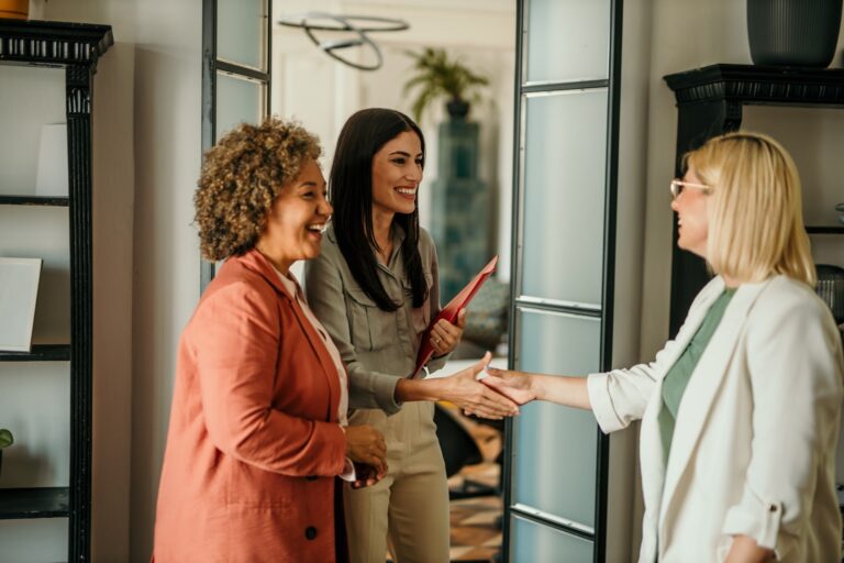 Estate agent greeting sellers at their Cardiff home