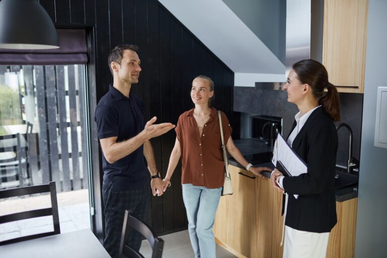 Letting agent showing a couple around a modern rental home during a viewing in Newcastle