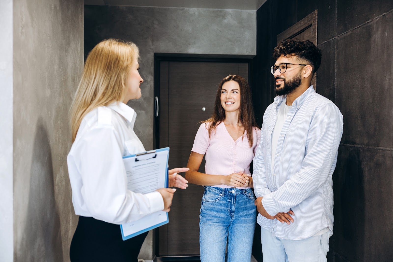 Estate agent showing buyers a home in Pontypridd