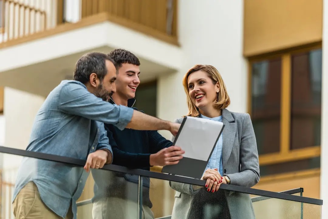 Estate agent presenting a home to buyers in Warrington