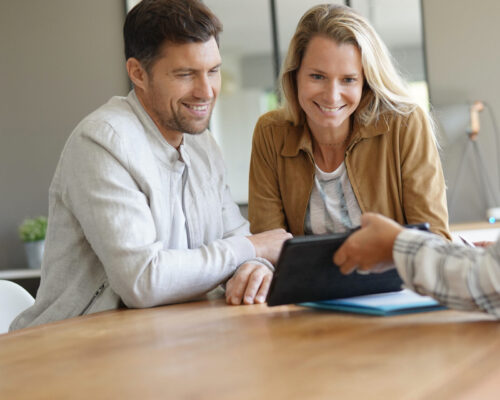 Couple meeting real-estate agent in office