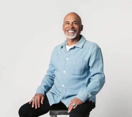 Happy retired man sitting on a stool